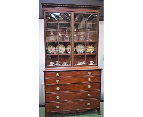 A George III mahogany secretaire library bookcase, dentil cornice above a pair of rectangular doors with pointed arched glazi