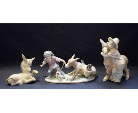 A Lladro ceramic figure group, Boy Pulling Donkey, 5178; others, Boy with Donkey, Donkey in Love (3)