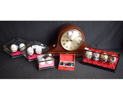 An early 20th century Napoleon hat mahogany mantel clock, Roman numerals; a cased set of Chinese eggs, hand painted with grot