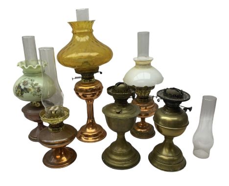 Copper and brass oil lamp with a corinthian column  chimney and yellow glass shade, together with five other similar examples