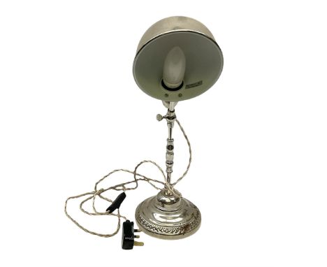 Chrome table lamp with adjustable head, on a circular plinth with relief decoration, untested, H40cm  