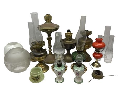 Oil lamp with a green glass reservoir, together with glass based oil lamp with glass chimney,  two brass lobed baluster form 