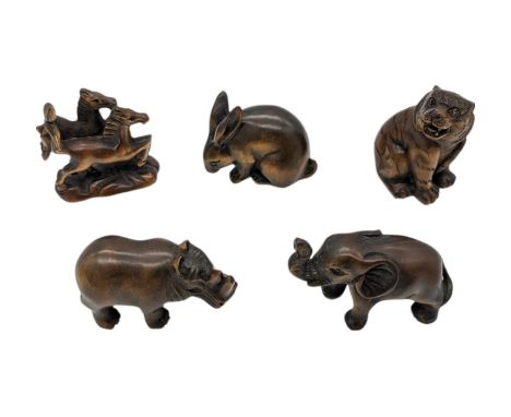 Five netsuke, modelled as two horses, rabbit, elephant, rhino and tiger