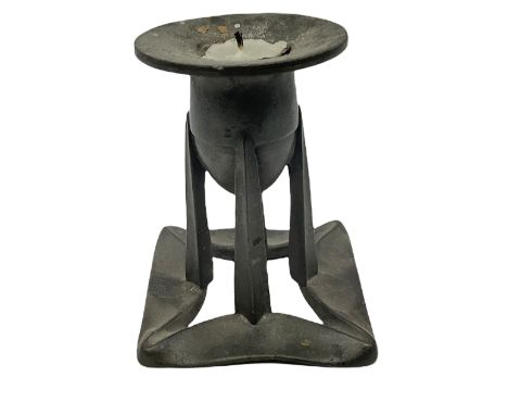 Liberty &amp; Co Tudric pewter candlestick designed by Archibald Knox, the bullet shaped socket upon four tapering supports a