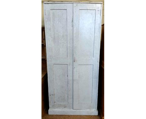 A painted two door cupboard, fitted with a shelf, 200 cm high x 92 cm wide