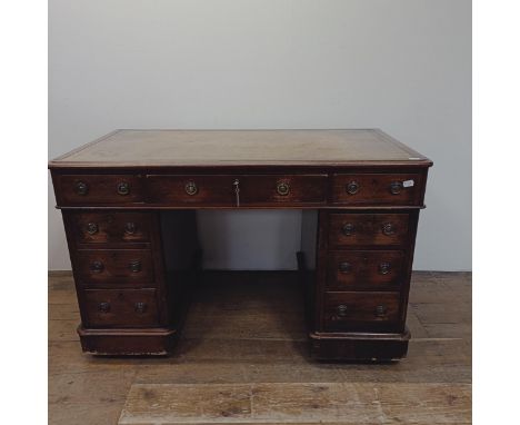 A mahogany pedestal desk, having nine drawers, 128 cm wide