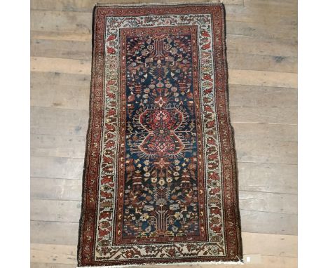 A Persian red ground rug, 200 x 112 cm