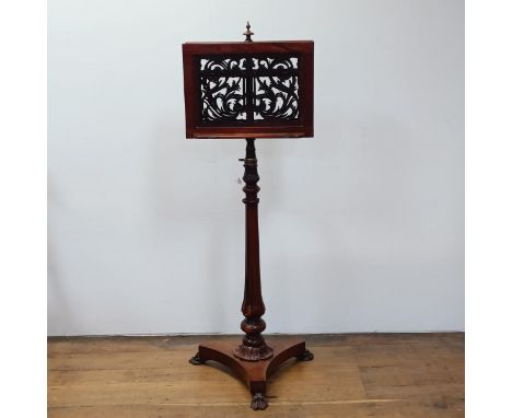 A 19th century rosewood duet stand, with two pierced adjustable music holders, on a carved column support, to a triangular ba