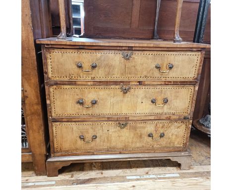 An early 19th century walnut chest, having three long drawers, with herringbone crossbanding, 109 cm wideSome water stains to