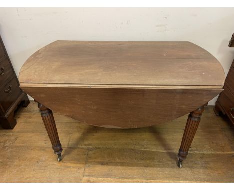 A mahogany drop leaf table, on reeded legs, 125 cm wideWhen open this is a circular table