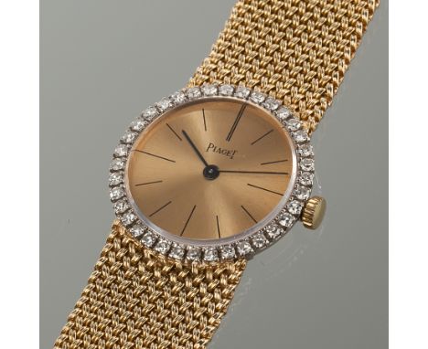 OUTSTANDING LADY'S EIGHTEEN CARAT GOLD DIAMOND SET PIAGET WATCH
the gold tone dial set with baton hour markers, the bezel set