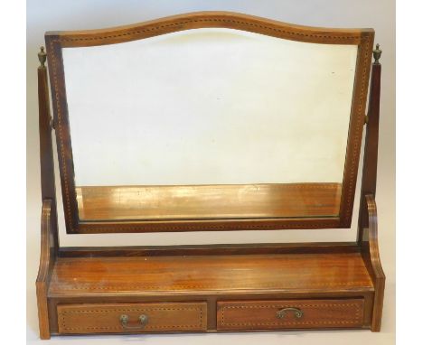 An Edwardian mahogany and checker banded dressing table mirror, the shaped bevelled plate on tapering supports, headed by tur