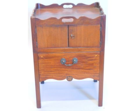 A George III mahogany night commode, with four pierced handles above two doors and a pull out drawer with an inlaid pull out 