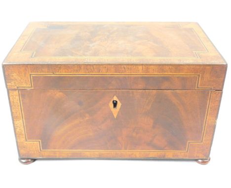 An early 19thC mahogany tea caddy, with figured central section surrounded by ebony and boxwood stringing, the hinged lid enc