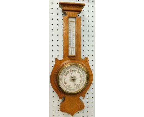 An early 20thC Art Nouveau style barometer, in oak case with thermometer, 56cm high 