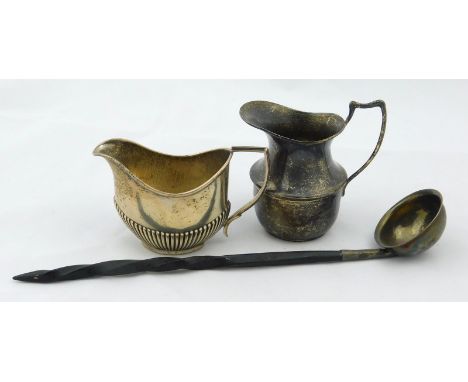 Three items of small silver, to include two cream jugs, one with part fluted decoration and a small ladle with twisted whale 