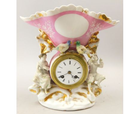 A 19thC Paris porcelain centrepiece, mounted with a clock, the figural case applied with birds etc., 25cm high