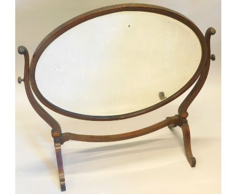 An Edwardian mahogany and checker banded dressing table mirror, an oval bevelled plate on shaped supports, with splayed legs,