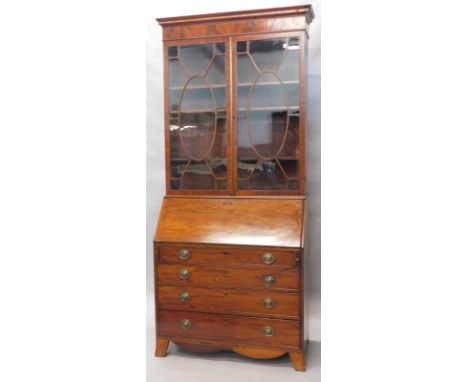 An early 19thC mahogany bureau bookcase, the overhanging inlaid fixed cornice raised above a pair of astragal glazed doors, h