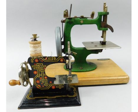 Two miniature sewing machines, to include one with label for Grain and another tin plate example.