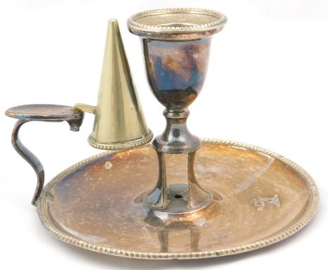 An early 19thC Sheffield plate chamberstick, with snuffer, with a gadrooned border, crest engraved