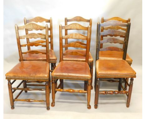 An associated set of six ash Lancashire type ladderback chairs, each with turned supports, a shaped ladder, a maroon leather 