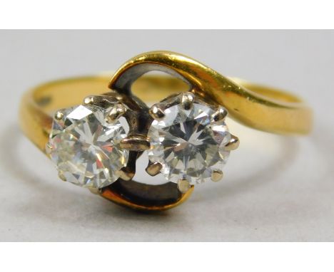 An 18ct gold two stone diamond dress ring, set with two round brilliant cut diamonds, each approx 0.47cts, in a twist design,