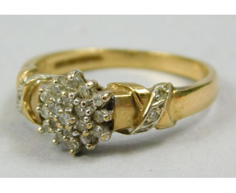 A 9ct gold dress ring, set in a floral cluster, with white stones, and patterned shoulders, 3.1g all in. 