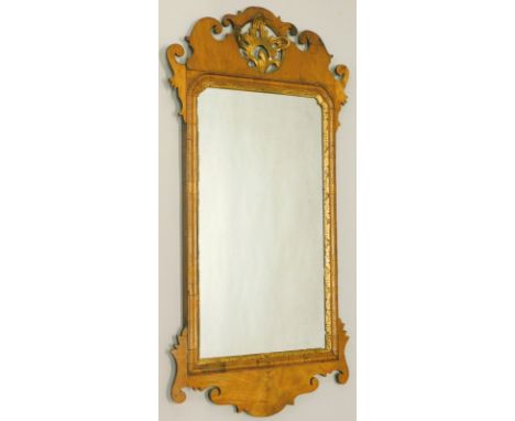 A walnut fret frame wall mirror in mid 18thC style, the shaped crest with a central gilt pierced shell motif, above a rectang