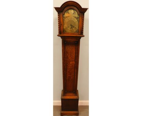 A 1930's oak grandmother clock, the brass arched dial engraved Tempus Fugit, flanked by spirally turned supports to the hood,