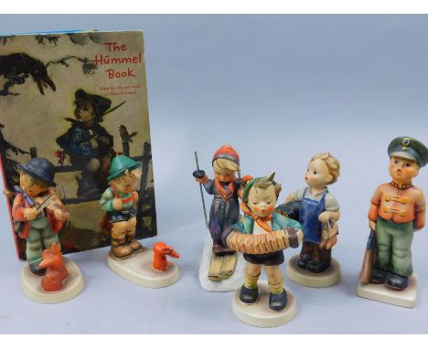 Six Goebel Hummel figures, to include a skier, boy with rabbit, accordion player, violin player and a Hummel book (7)