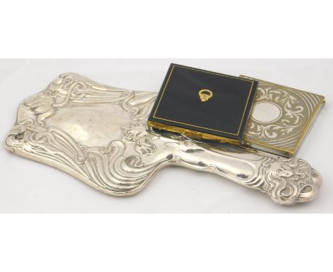 An Edward VII Art Nouveau silver backed hand mirror, with embossed floral and mask decoration, Birmingham 1904, together with