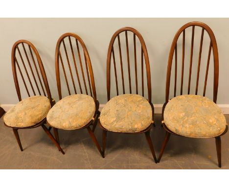 A set of four Ercol stickback kitchen chairs, each with a solid seat, on turned tapering legs