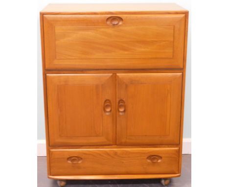 An Ercol light elm secretaire cabinet, with a fall front section above two doors and a frieze drawer, on castors, 82cm wide