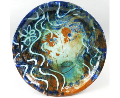 A studio pottery plaque, decorated with a female figure, impressed stamp to other underside RB possibly Danish, 33cm dia.