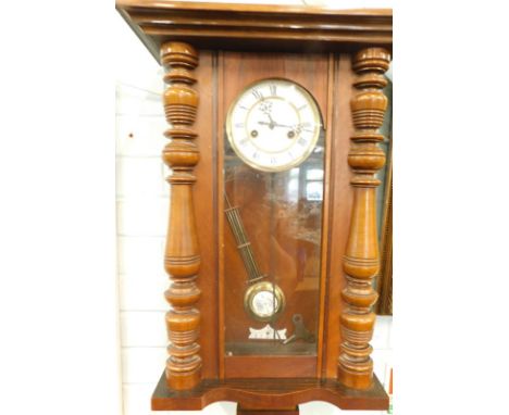 A Vienna type walnut wall clock by Gustav Becker, the enamel dial with Roman numerals, 68cm high.