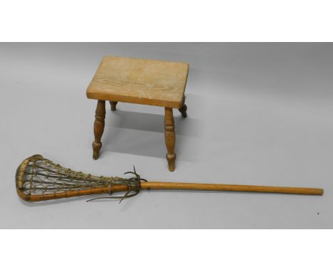 A late 19thC/early 20thC ash and elm stool, with turned legs, 32.5cm wide and a Lacrosse stick (2)