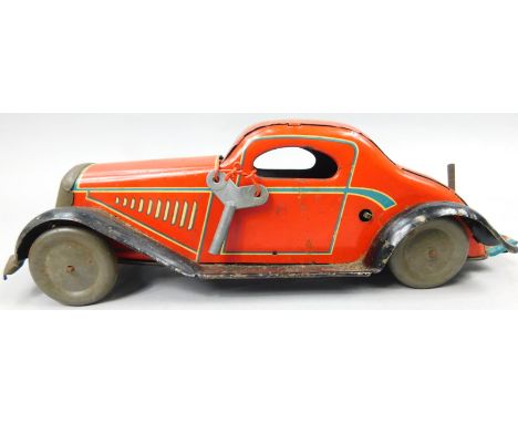 A British tin plate clockwork motor car, stamped Made in England and British Made, 32cm long