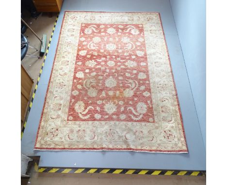 A cream-ground Afghan Ziegler carpet. 295x205xcmAreas of fading. No fringe. In need of a clean. 