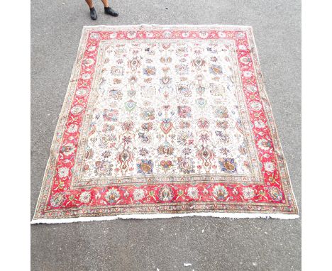 A red and cream-ground Tabriz carpet. 334x293cm. 