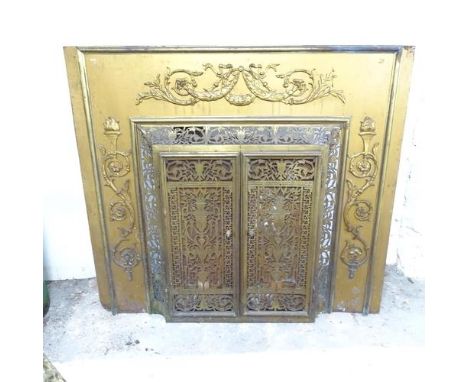 An antique brass fronted fireplace with applied and pierced decoration. 105x95x30cm.Fireplace has no obvious damage or repair