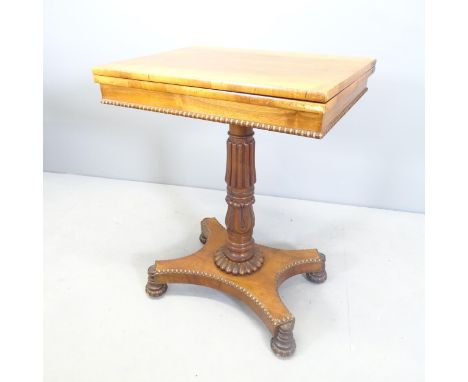 A Victorian mahogany fold over games table. The reeded column with gadrooned collar sat on a shaped quadruped platform base. 