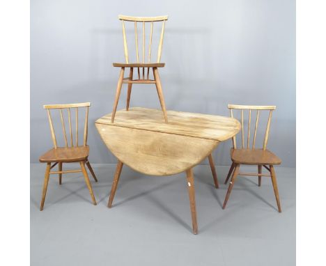 An Ercol drop-leaf dining table, 114x72x61cm (extending to 123cm), and three Ercol stick back dining chairs.One chair has rem