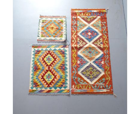 A Chobi Kilim runner. 150x60, a Chobi Kilim mat, 79x59cm, and another, 48x49cm. (3) 