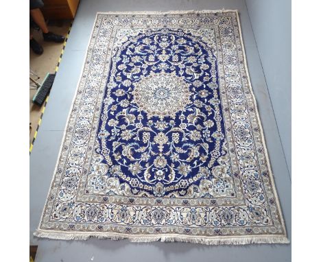 A cream and blue-ground part silk Isban carpet. 297x200cm.Good overall condition. Both long edges have been leather bound to 