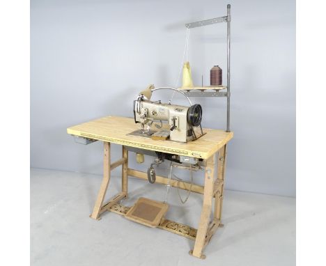 A Pfaff flat bed sewing machine on work table, dimensions (table) 122x75x51cm.From the workshop of saddle maker Brian R. Borr