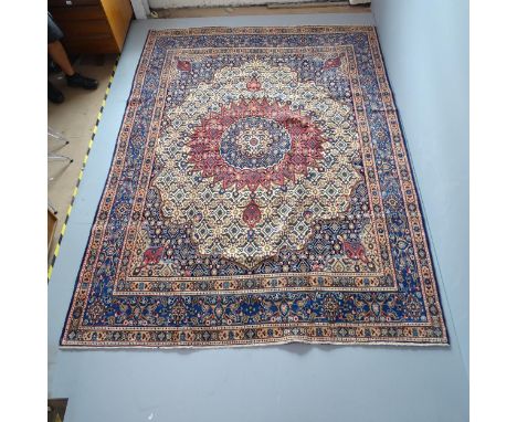 A blue-ground Mood carpet. 305x226cmFringe missing, otherwise good condition. 