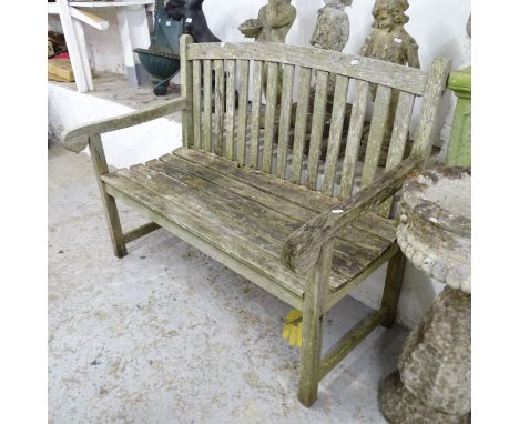 A weathered teak slatted garden bench, with label for Firman Leisure. 121x94x65cm. 