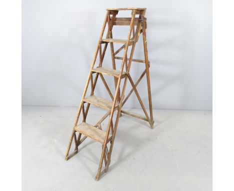 A vintage pine folding step ladder, with metal plaque reading "The Hatherley folding lattistep". Height 130cm.