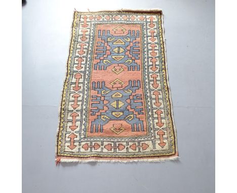 A small salmon-ground Afghan runner. 135x85cm.Loss of fringe to both ends. Signs of wear. Would benefit from a clean. 
